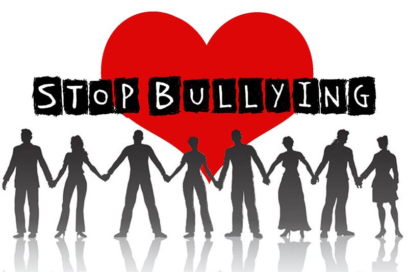 Silhouette of people holding hands in front of a heart symbol - text says "stop bullying"